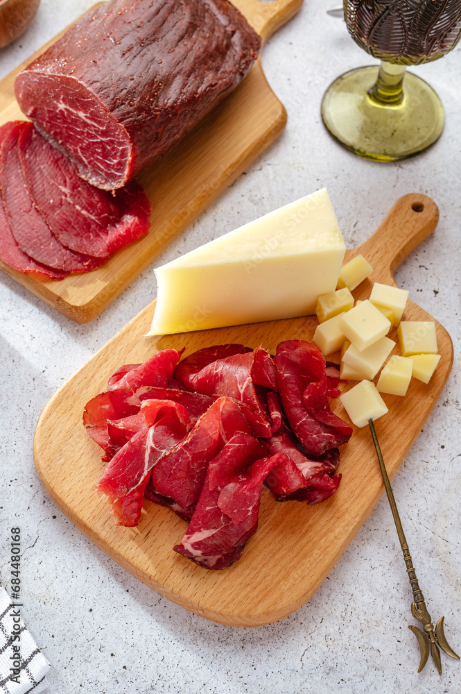 homemade beef delicatessen meat with spices cut on a wooden board homemade beef delicatessen meat with spices cut on a wooden board