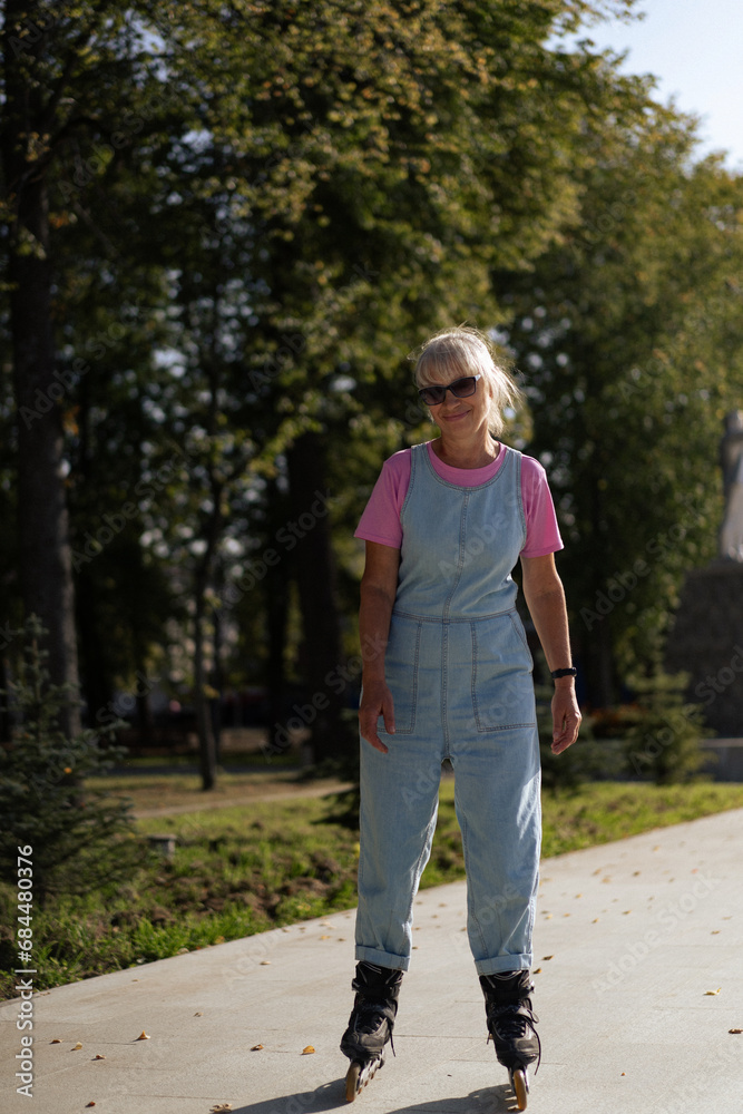 Middle-aged woman roller-skates in the city. Middle age entertainment. Middle-aged woman roller-skates in the city. Middle age entertainment.