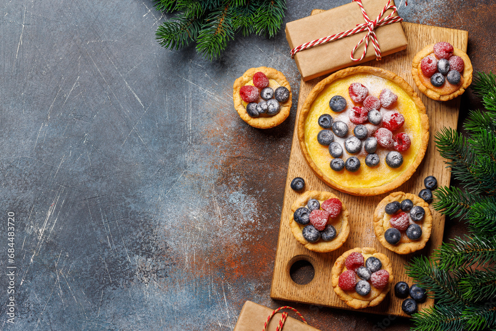 Festive delight: Christmas cupcakes adorned with berries Festive delight: Christmas cupcakes adorned with berries