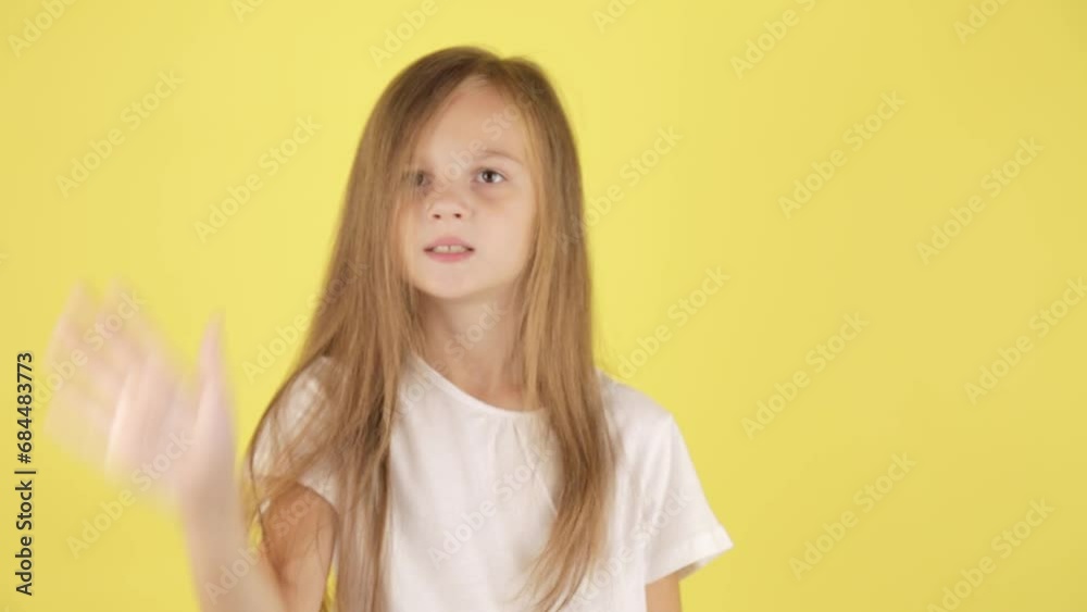 Hello concept. Cute little caucasian girl child waving meeting greeting with hands as notices someone, isolated on yellow studio background wall. Hello concept. Cute little caucasian girl child waving meeting greeting with hands as notices someone, isolated on yellow studio background wall.