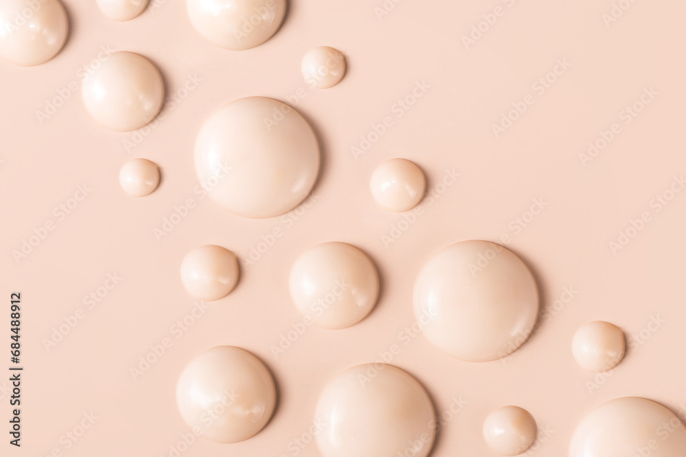 cosmetic smears drops of cream texture on beige background