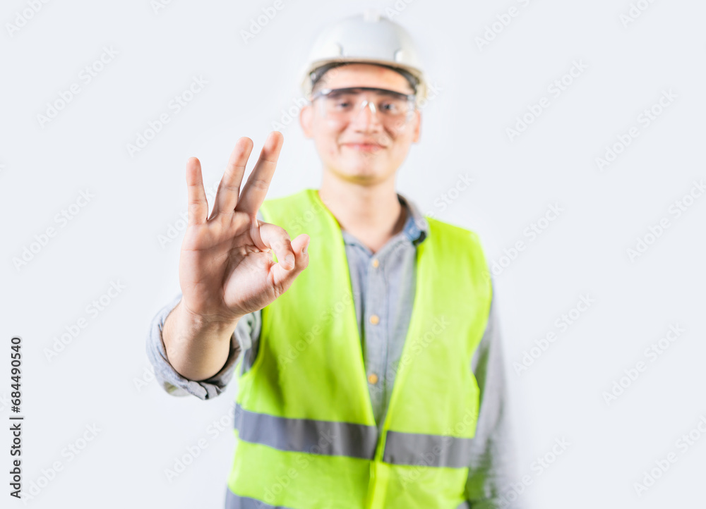 Young engineer counting number three isolated. Male engineer showing number three with fingers isolated