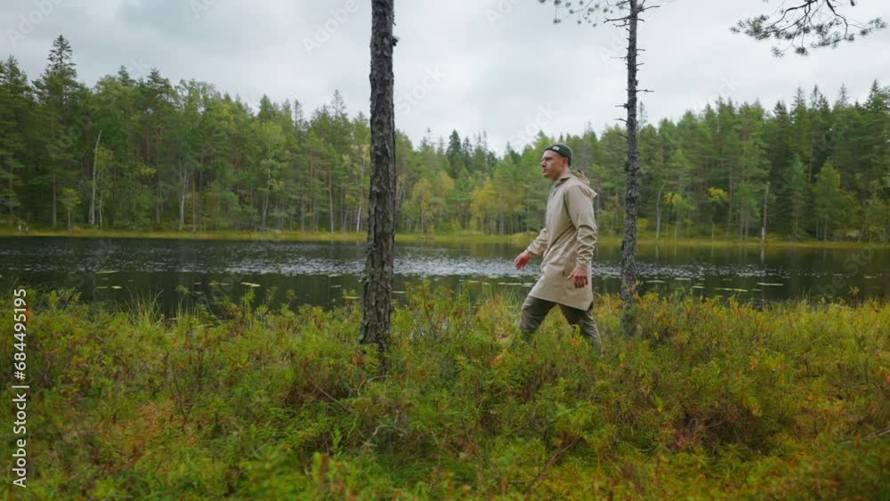 Man In Activewear Walking On Coast Of Beautiful Lake In Forest In Autumn Day, Tourism In Woodland Man In Activewear Walking On Coast Of Beautiful Lake In Forest In Autumn Day, Tourism In Woodland