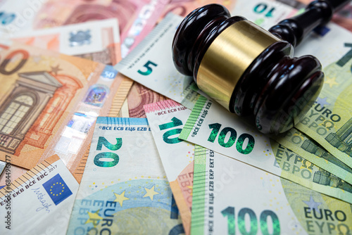 rule of law and auctions with judge's gavel and euro banknotes photo