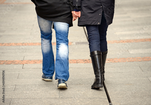 Geneva, Switzerland, Europe - couple walking hand in hand, rear view, street scene