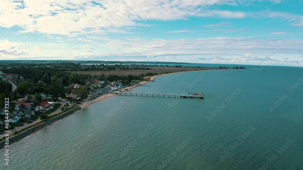 Aerial view of drone flying above the pier in Mechelinki, Poland with baltic sea in the background Aerial view of drone flying above the pier in Mechelinki, Poland with baltic sea in the background
