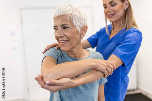 Wallpaper Mural Professional therapists is stretching muscles, senior patient with abnormal muscular symptoms, physical rehabilitation therapies and treatment of physiological disorders by physiotherapists concept. Torontodigital.ca