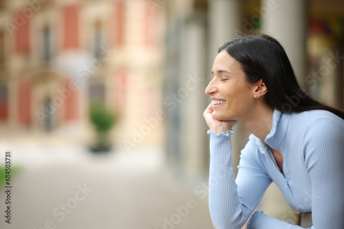 Happy woman relaxing with closed eyes photo
