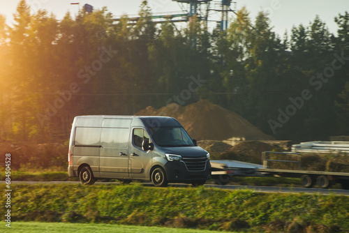 A commercial van truck on the highway, delivering goods and products across the country, using fast and reliable modes of freight transportation.