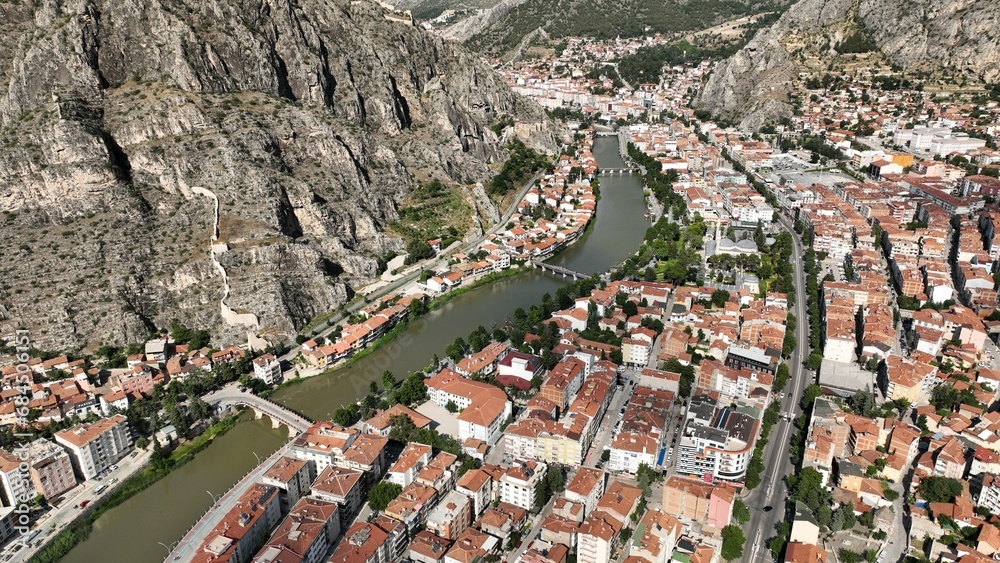 A photo of Amasya old city center taken with a drone. Traditional houses located on the banks of the Yesilirmak River.