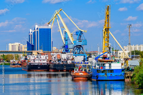 Cargo ships stand in the port of Astrakhan on the Volga River, Astrakhan cargo port. Port cranes. photo