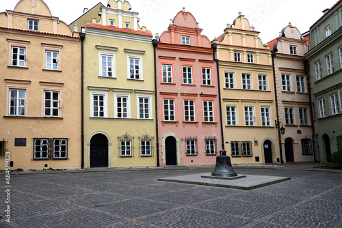 Warsaw, Poland, Europe - facades of townhouses and bell formely installed in St John's Archcathedral, Kanonia square, Old Town - UNESCO World Heritage Site