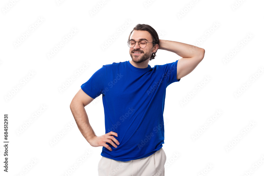 young confident brunette man with a beard dressed in a blue t-shirt on a studio white background young confident brunette man with a beard dressed in a blue t-shirt on a studio white background