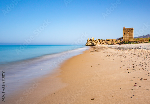 Italy, Sicily, Sandy beach with castle ruins in background photo