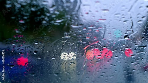 Footage of raindrops on the window and cars passing