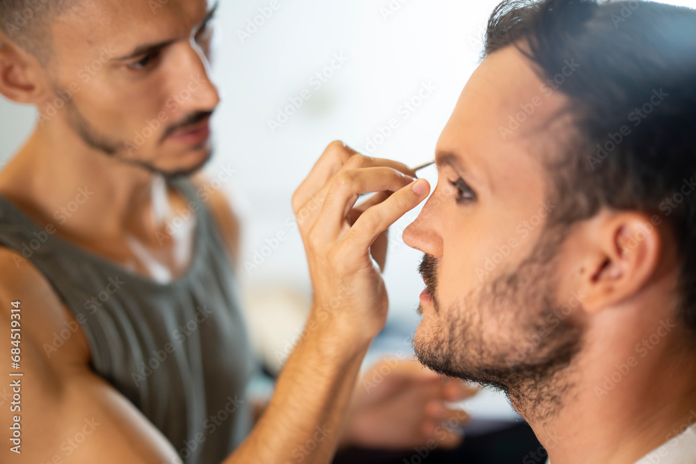 Beautician applying eyeshadow on customer Beautician applying eyeshadow on customer