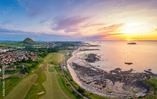 UK, Scotland, North Berwick, Aerial view of beach in front of coastal town at sunset photo