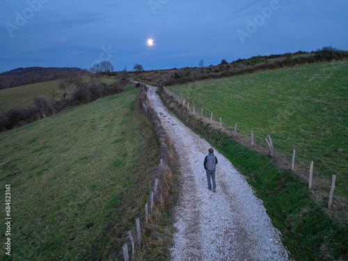 Obraz na plátně Hiker walking in the moonlight