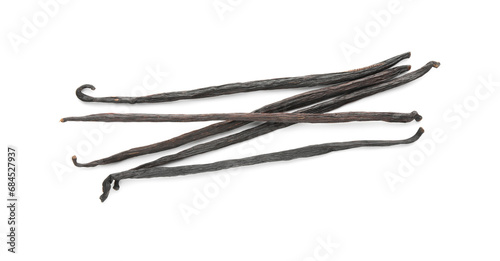 Many aromatic vanilla pods isolated on white, top view