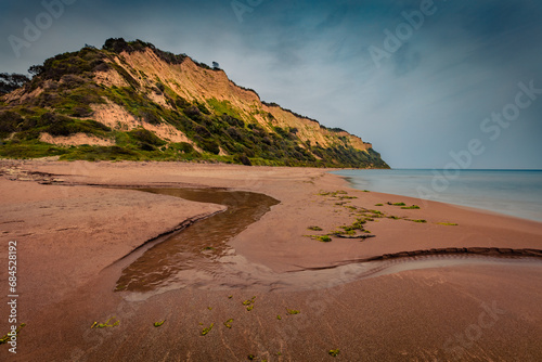 Gloomy spring view of Gardeno beach. Dramatic morning seascape of Ionian Sea. Captivating landscape of Corfu island, Greece, Europe. Traveling concept background. photo