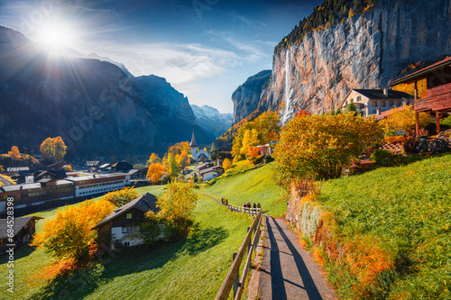First sunlight glowing Lauterbrunnen village valley. Majestic outdoor scene in Swiss Alps, Bernese Oberland in the canton of Bern, Switzerland. Traveling concept background. photo