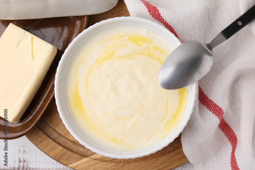 Bowl of delicious semolina pudding with butter served on table, top view Bowl of delicious semolina pudding with butter served on table, top view