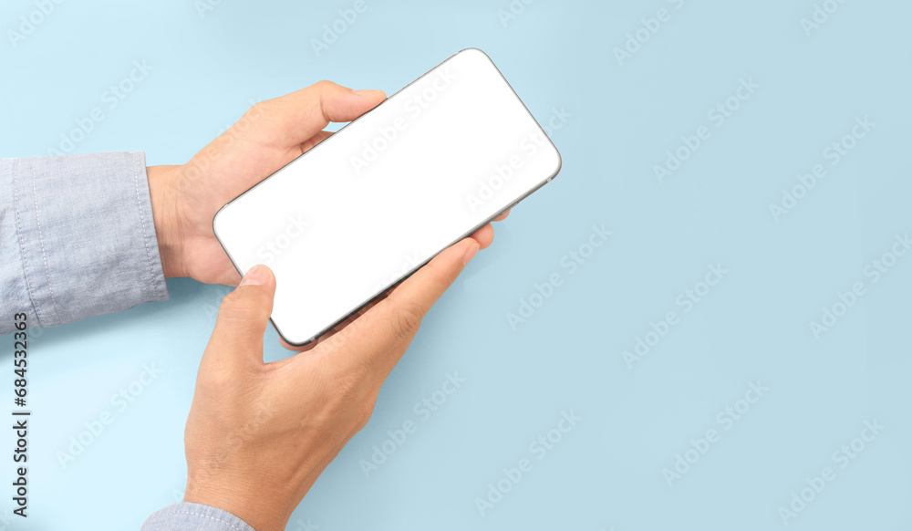 Obraz premium Hand holding smartphone device touching screen