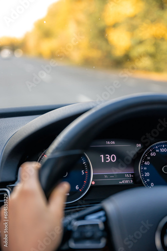 Steering wheel in a car close up, high speed driving on the road.