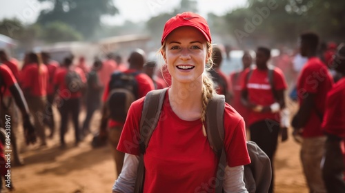 community of volunteers in red shirts helping people in africa photo