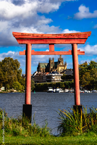 Japanese Torii gate in Metz at the plan d’eau with the Saint Stephen cathedral in the background photo