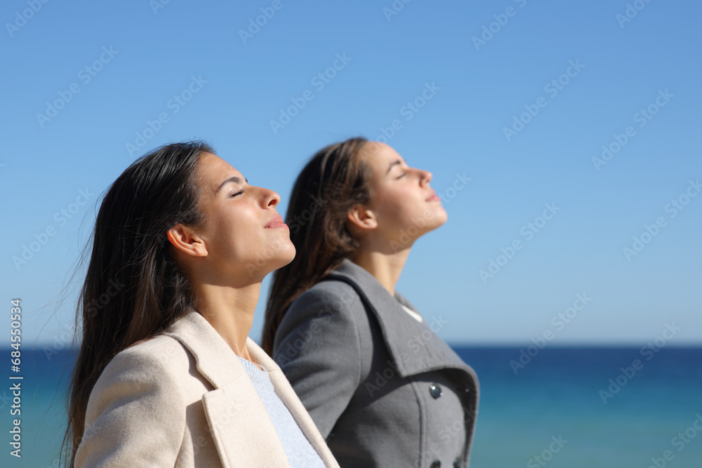 Two women breathing fresh air in winter