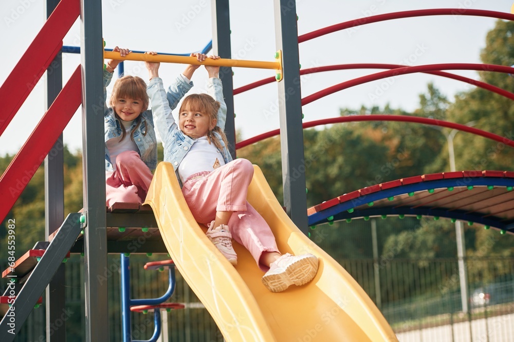 Children are active, smiling. Kids are having fun on the playground
