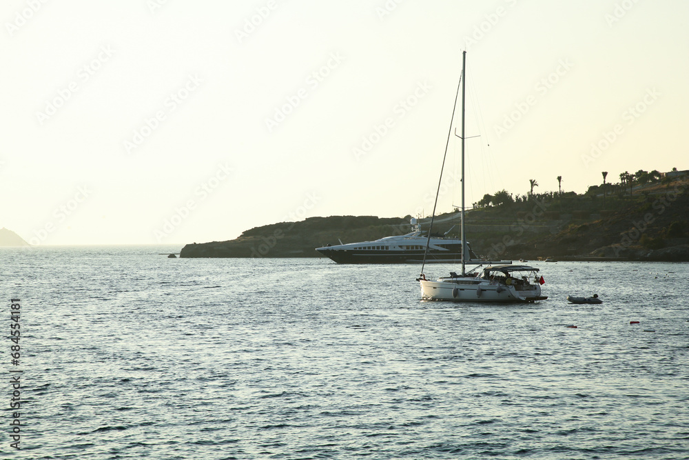 Beautiful view of calm sea with yacht and boats on summer day Beautiful view of calm sea with yacht and boats on summer day