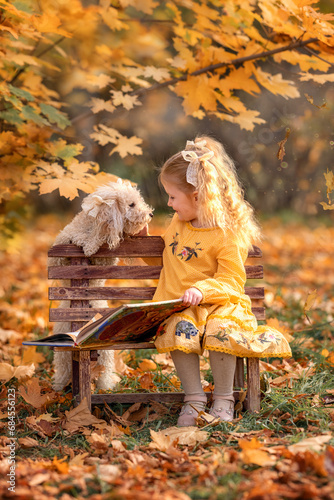 Little girl child and dog in autumn forest. Female kid and pet portrait at nature with yellow autumn leaves in park during fall outdoor.