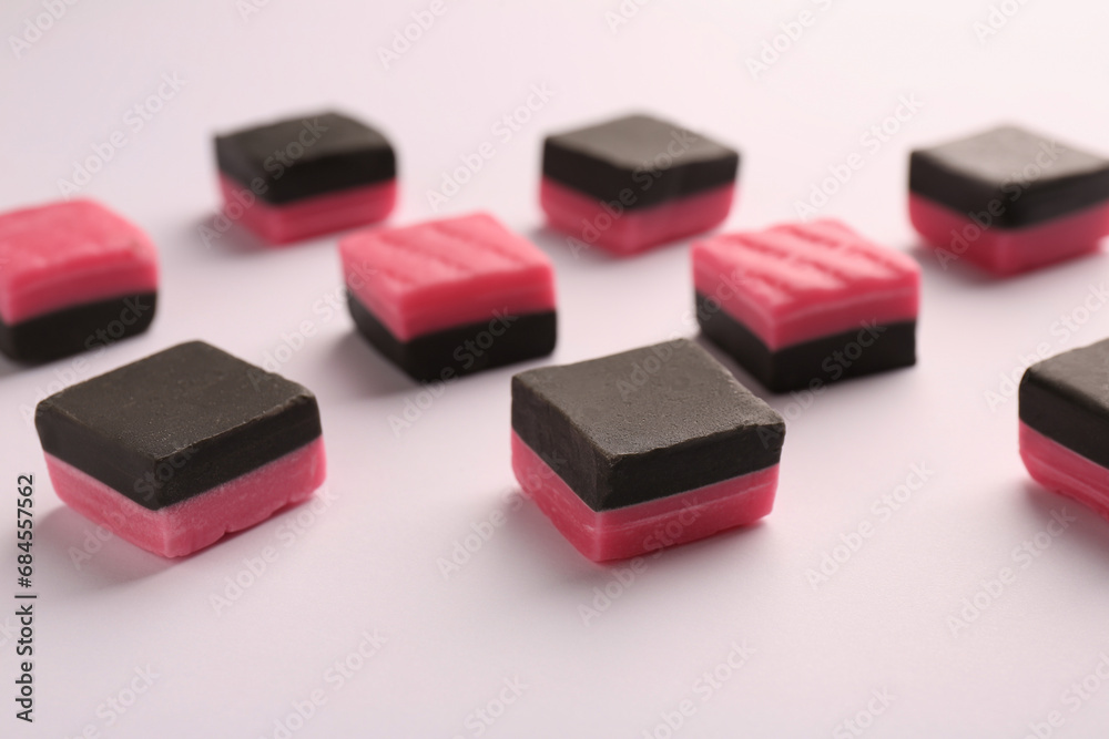 Tasty liquorice candies on light background, closeup Tasty liquorice candies on light background, closeup