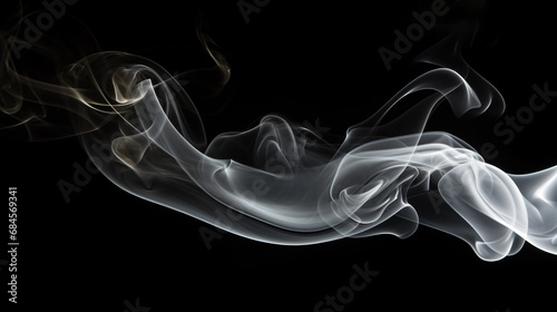 Smoldering cigarette smoke on black