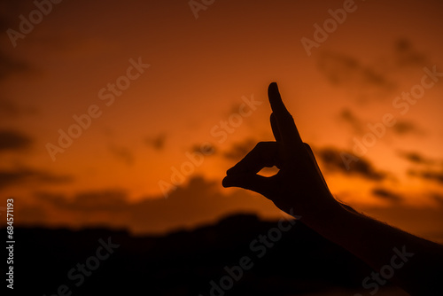 silhouette of a person holding hands, deer shape hand silhouette in cloud sky