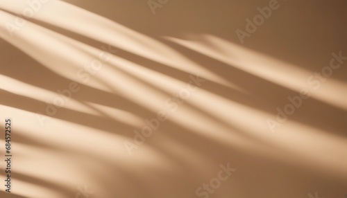 A soft, warm beige background with a smooth surface illuminated by natural sunlight