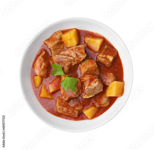 Delicious goulash in bowl isolated on white, top view