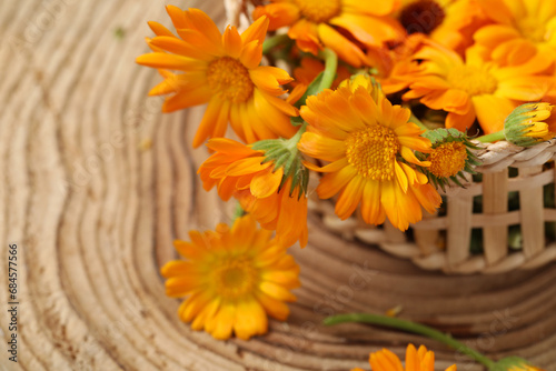 Beautiful fresh calendula flowers on wooden table, closeup. Space for text