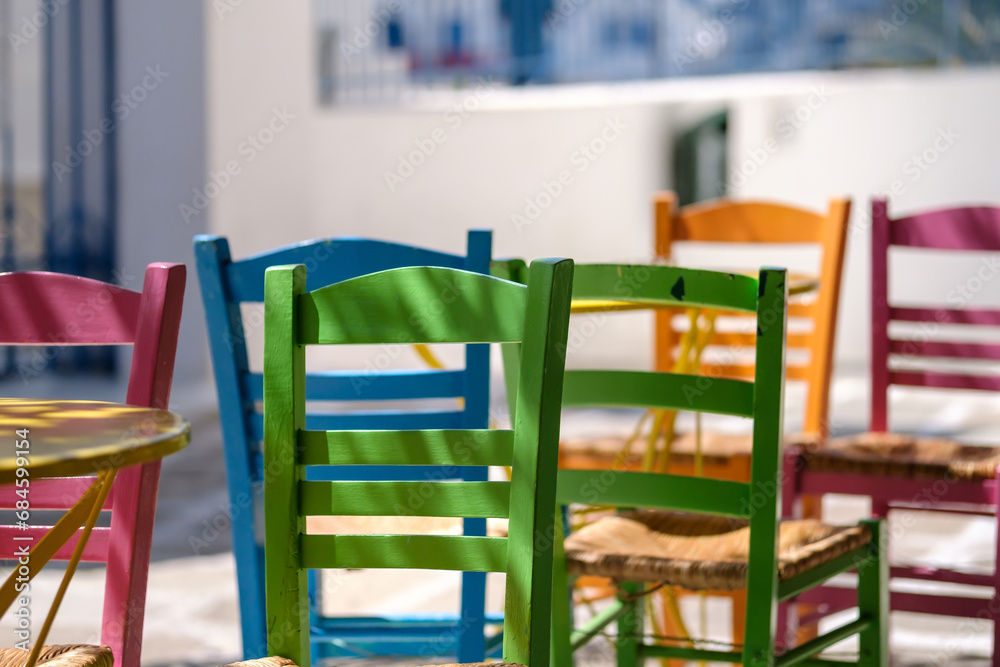 View of colourful chairs and tables at a picturesque bar in Ios Greece