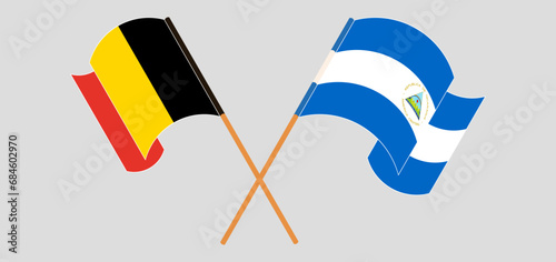Crossed and waving flags of Belgium and Nicaragua photo