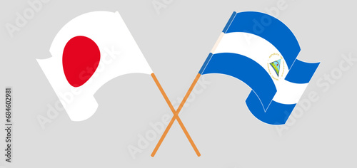 Crossed and waving flags of Japan and Nicaragua