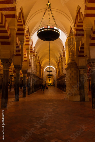 Cordoba, Spain, September 13, 2021: Interior view of the Mosque-Cathedral Monumental Site of Cordoba. The famous Red and white arches of La Mezquita.