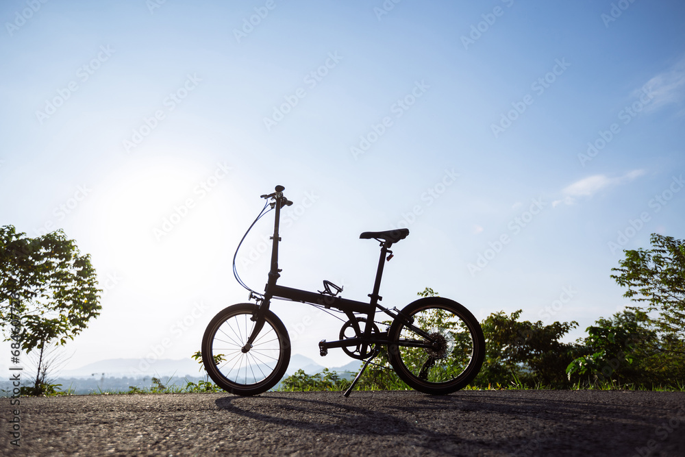 A folding bike on sunrise mountain top road