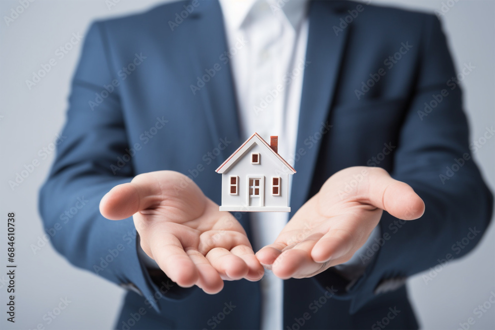 hands holding a small house, close-up. Concept of deal and real estate hands holding a small house, close-up. Concept of deal and real estate