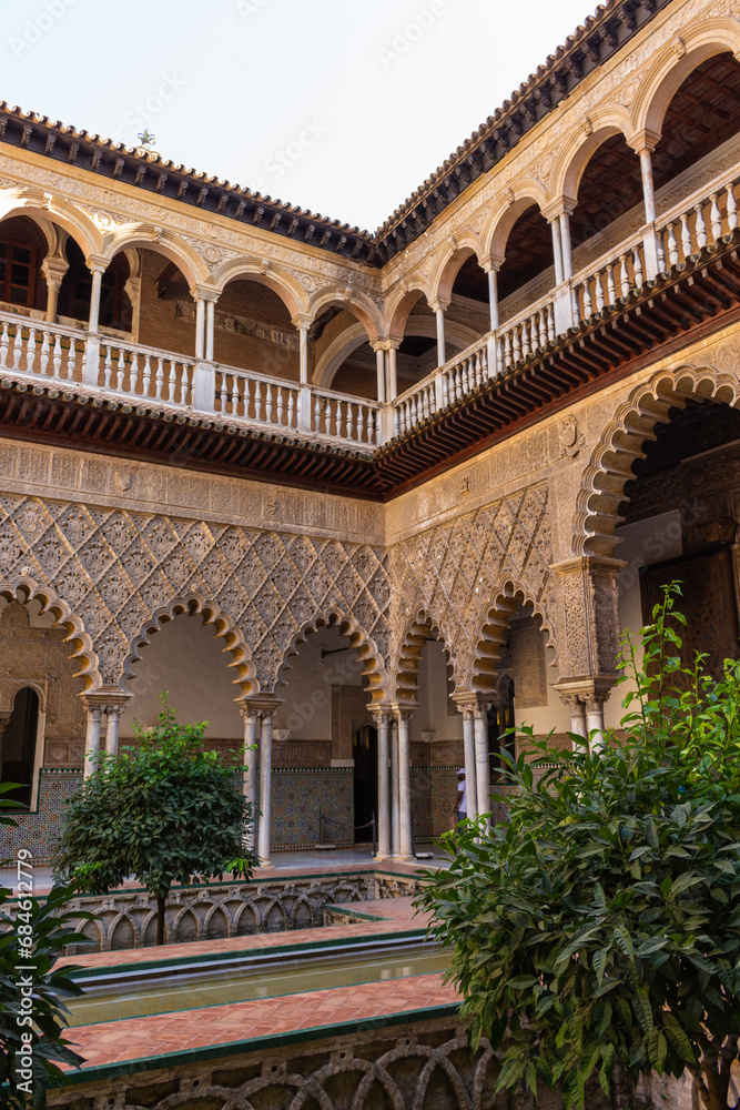 Seville, Spain, September 12, 2021: The Royal Palace of Seville (Real Alcazar). The Maidens Courtyard. The Mudejar of Pedro I on the ground floor and the Renaissance of the first monarchs.