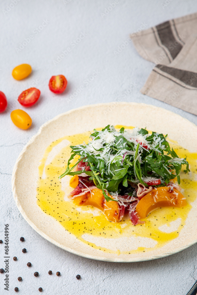 green salad with arugula and lingonberries on a white plate and marble background side view green salad with arugula and lingonberries on a white plate and marble background side view