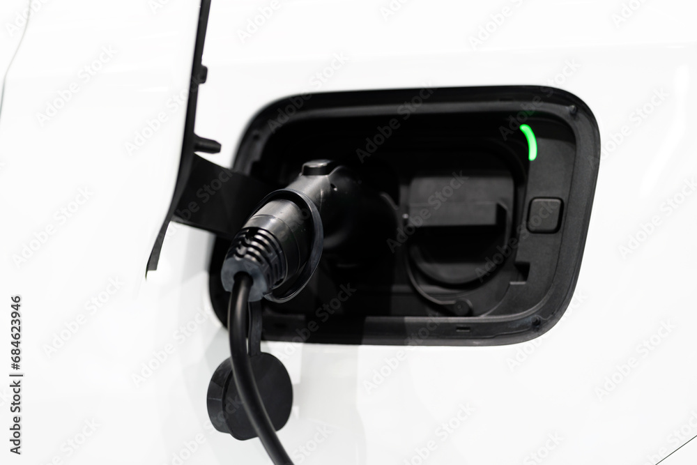 Electric car is charging in power station