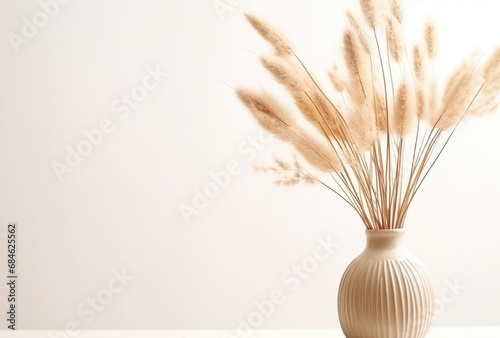 a vase of dried dried grass are sitting on a white surface